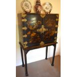 An 18th century Chinoiserie red and black lacquered gold heightened cabinet on stand, the twin