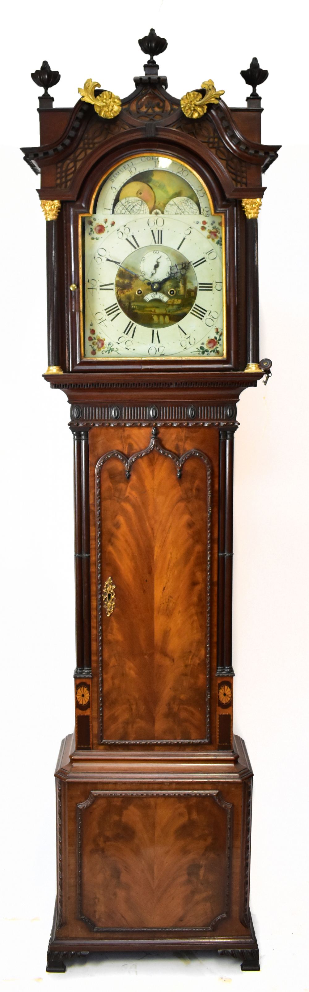 A George III mahogany and inlaid longcase clock, the elaborate swan neck pediment above fret