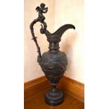 A very large 20th century Italian bronze ewer with cherubic mount above the grape and vine adorned