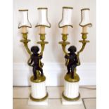 A pair of white marble bronze and ormolu twin light cherubic table lamps, each with fluted marble