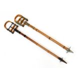 Two Edwardian bamboo and metal mounted shooting sticks (2).