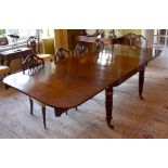 A Regency mahogany campaign dining table with brass mounted lobed tapering legs to substantial brass