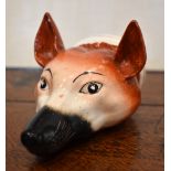 A 19th century Pratt type fox head stirrup cup with painted detail, unmarked, length 13cm.