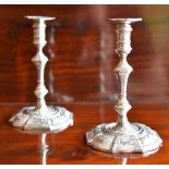 A pair of Elizabeth II hallmarked silver taper sticks in the 18th century manner, each with