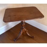 An early/mid-19th century mahogany tripod occasional table, the rounded rectangular top above turned