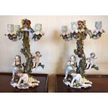 Two late 19th century German porcelain candelabra, each floral encrusted throughout with four