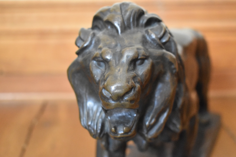 AFTER ANTOINE LOUIS BARYE; a large bronze figure of a lion standing four square, on rectangular - Image 3 of 3