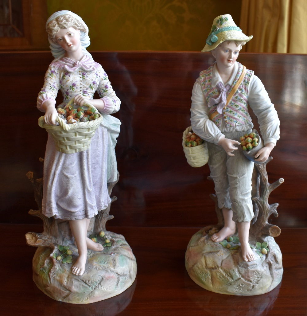 A large pair of late 19th century Continental bisque porcelain figures of a young gentleman and