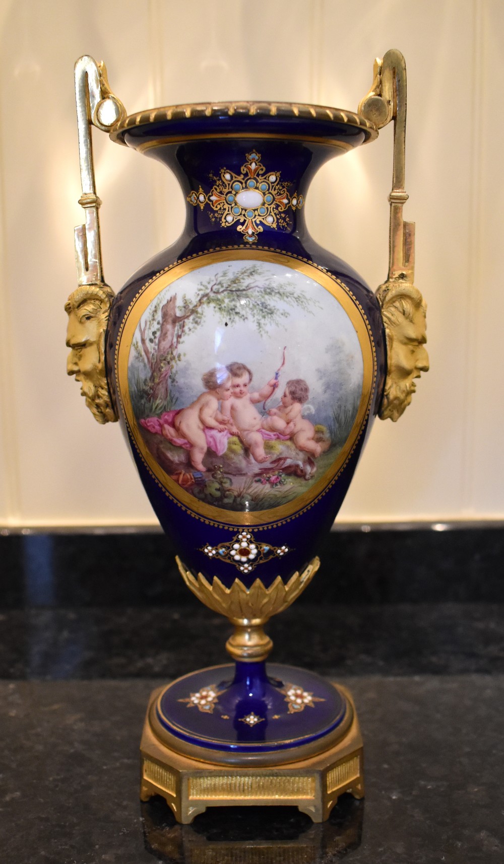 A late 19th century French porcelain ormolu mounted vase, the dark blue ground set with enamel '