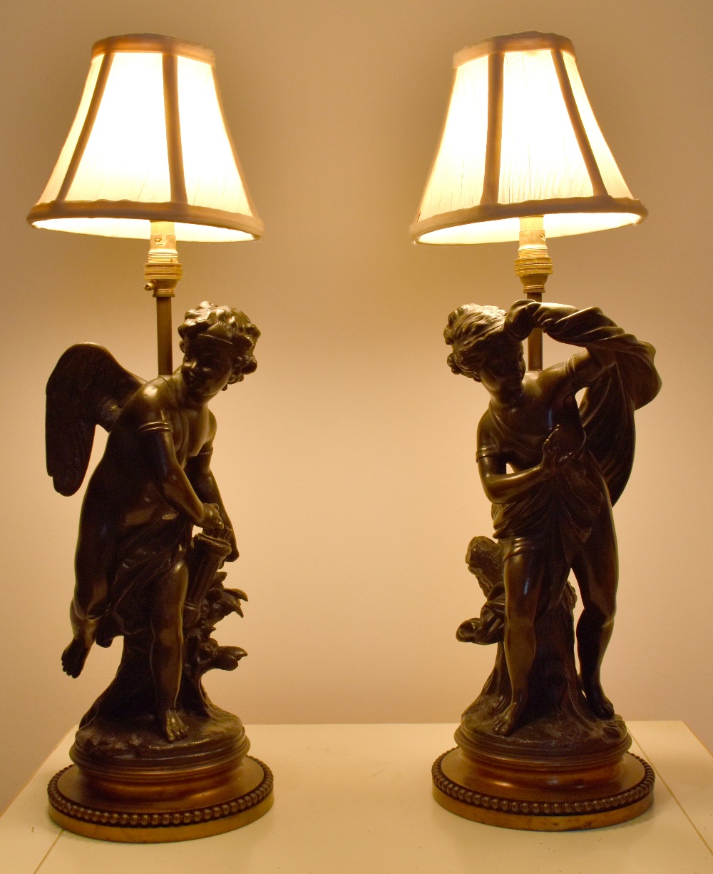 AFTER MARIN; a pair of 20th century bronze figural table lamps, each raised on bead decorated