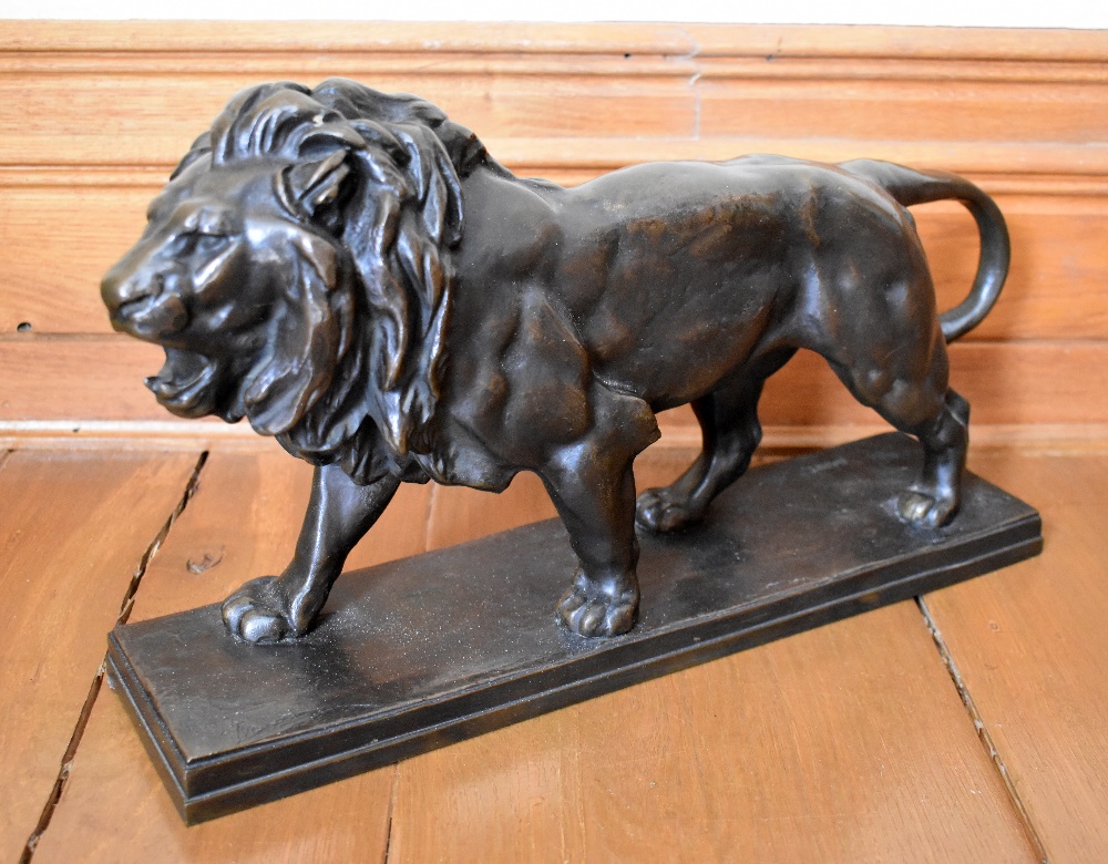 AFTER ANTOINE LOUIS BARYE; a large bronze figure of a lion standing four square, on rectangular