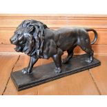 AFTER ANTOINE LOUIS BARYE; a large bronze figure of a lion standing four square, on rectangular