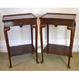 A pair of reproduction mahogany two tiered side tables in the Georgian manner, each tray top above a