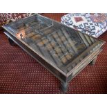 A rectangular glass topped coffee table formed from an early Eastern door with stud and embossed