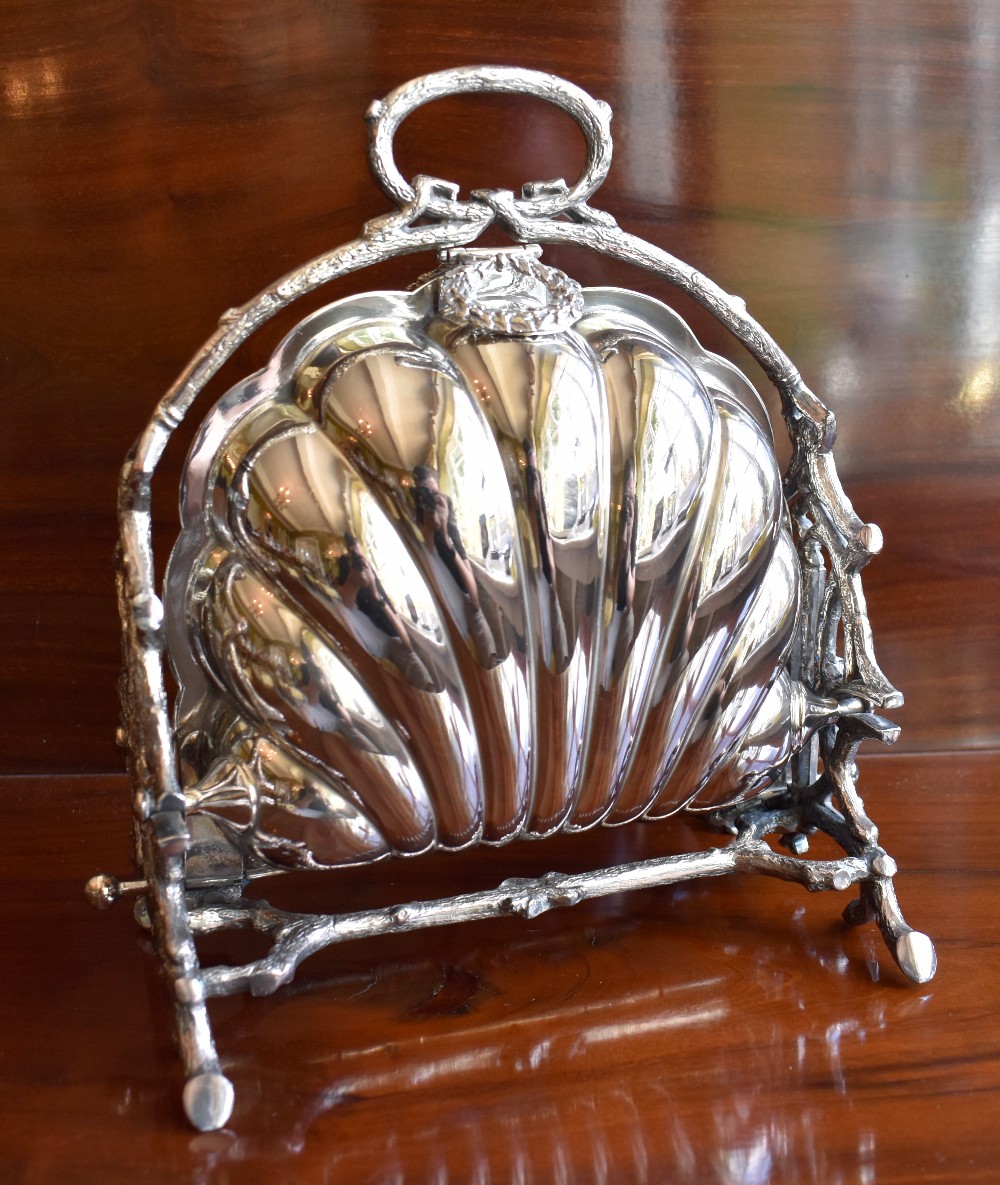 WALKER & HALL; a silver plated biscuiteer of shell form, with twin hinged sections, interior pierced