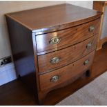 An early 19th century mahogany line inlaid and crossbanded bowfront chest of three gradated