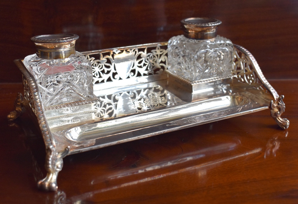 A late Victorian hallmarked silver ink standish with pierced three-quarter gallery, twin silver