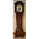 A George III oak longcase clock, the arched hood and dial with Roman numerals to the silvered