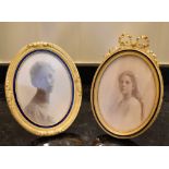 Two circa 1900 oval photograph frames, each with band of blue enamel detail and one with pierced