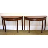 A pair of late George III mahogany line inlaid and satinwood crossbanded demi-lune tea tables,