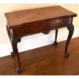 A George II mahogany tea table in the Irish taste, the rectangular top with stepped corners above