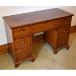 A late George III mahogany knee-hole desk, the rectangular top above a central frieze drawer flanked