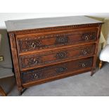 An early 19th century French oak three drawer commode with fluted uprights and turned feet, height