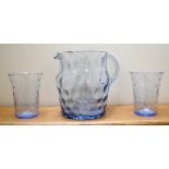 An Edwardian dimpled pale blue glass water jug, height 15.75cm and a pair of matching beakers (3).