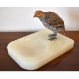 A 1930s cold painted bronze and polished onyx dish surmounted with a partridge, length 17cm, width