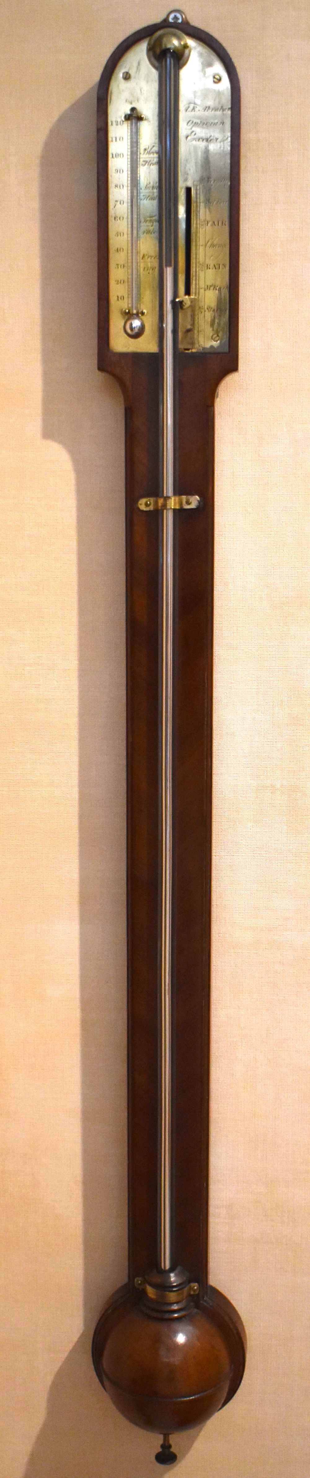 A George III mahogany stick barometer, the scale signed 'A. E. Abraham, Optician, Exeter', with