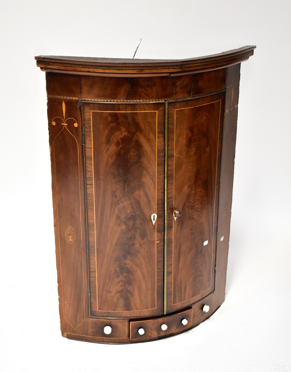 A 19th century flame mahogany inlaid wall-hanging corner cabinet,