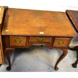 A George III and later oak lowboy, the crossbanded top above three drawers,