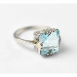 A platinum and blue stone, possibly aquamarine dress ring,