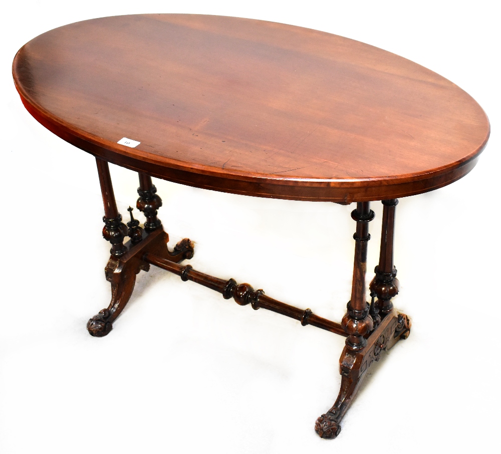 A 19th century mahogany oval top centre table with turned side columns and turned stretcher,