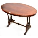 A 19th century mahogany oval top centre table with turned side columns and turned stretcher,