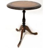 A 20th century mahogany leather-topped wine table on tripartite support, diameter 47cm,