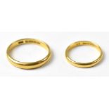 A pair of vintage 'His and Hers' 22ct gold band rings, sizes J and U, combined approx 6.8g (2).