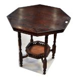 An early 20th century stained oak octagonal occasional table raised on turned and block supports