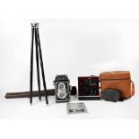 A vintage Lipca Rollop camera in brown leather carry case, a travel tripod in brown leather case,