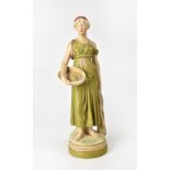 ROYAL DUX; a figure of Classically dressed maiden with head covering, carrying a basket with fish,