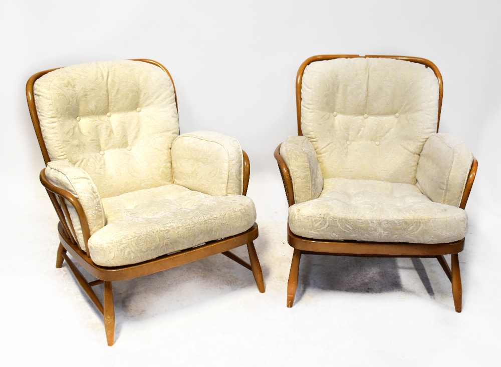 ERCOL; a set of four Jubilee stick back lounge chairs with turned cross stretchered supports (4).