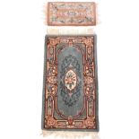 An Oriental washed wool green ground rug with pink floral decoration, 160 x 78cm,