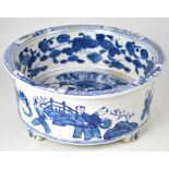 A modern blue and white Chinese-style planter with figural decoration, to four raised supports,
