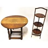 An early/mid-20th century small oak drop-leaf side table to turned supports and cross-stretcher,