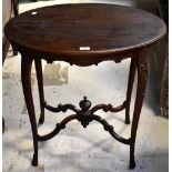 An early 20th century mahogany oval occasional table with shaped frieze,