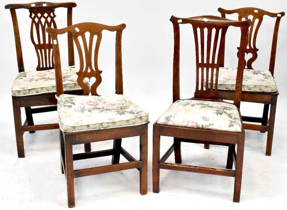 A harlequin set of four Georgian oak splat back dining chairs,