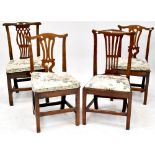 A harlequin set of four Georgian oak splat back dining chairs,