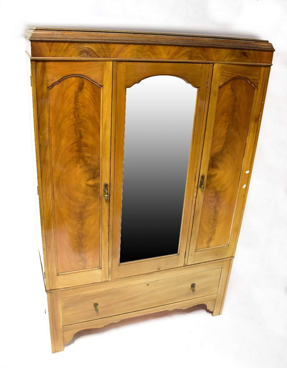 An Edwardian four-piece bedroom suite comprising a swing mirror back dressing table with serpentine