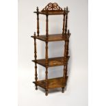 An Edwardian walnut inlaid four-tier whatnot, each tier supported by wrythen turned supports,