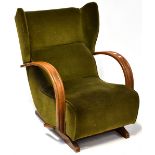 An Art Deco walnut framed wing back rocking lounge chair upholstered in green velour.